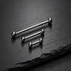 Three internally threaded straight barbells with ball ends on dark textured background