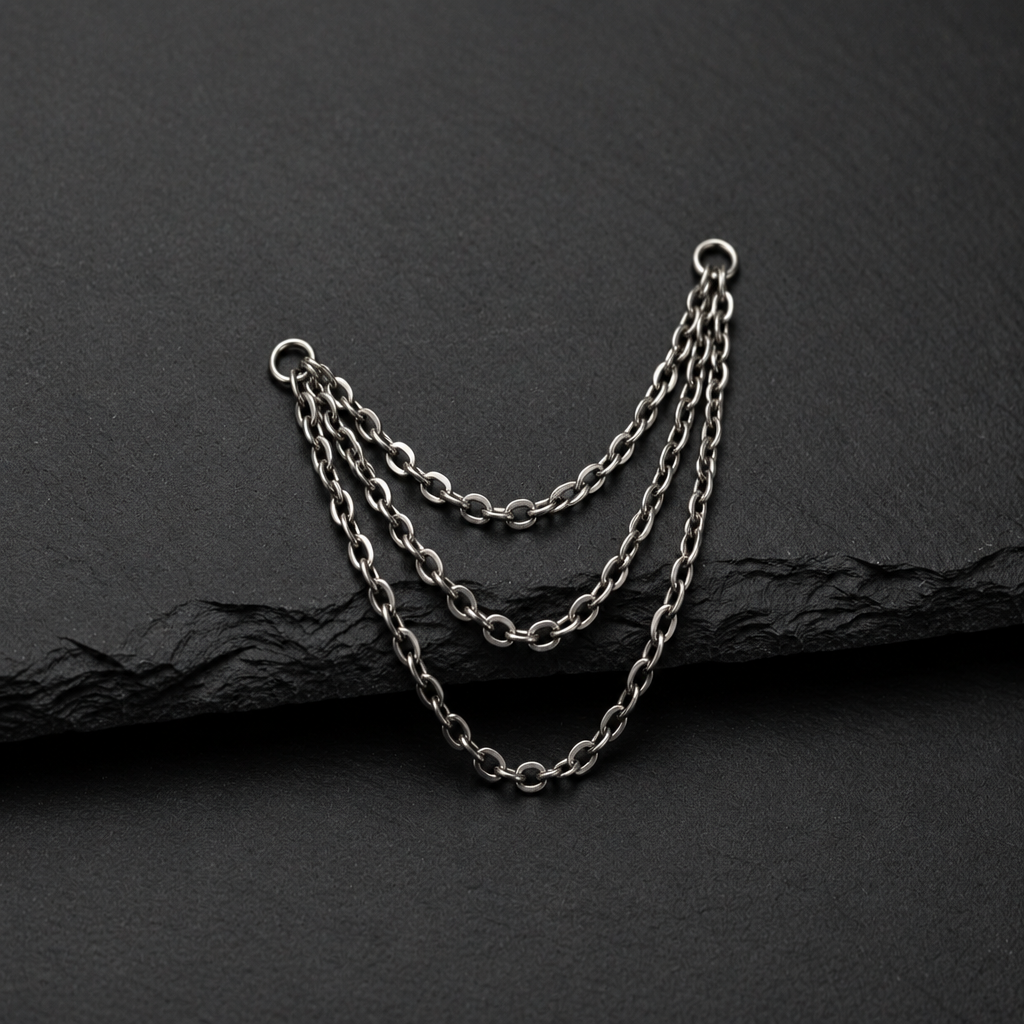 Three piercing chains on a dark textured background