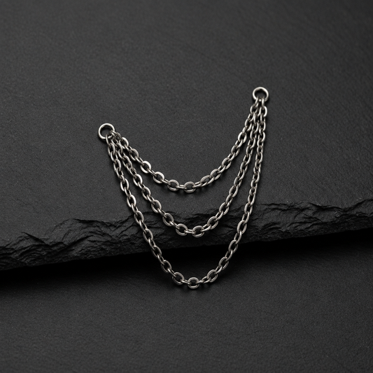 Three piercing chains on a dark textured background